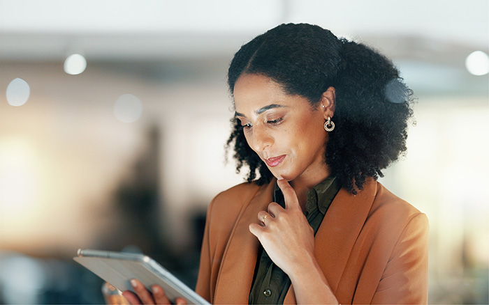 Businesswoman reading content on tablet